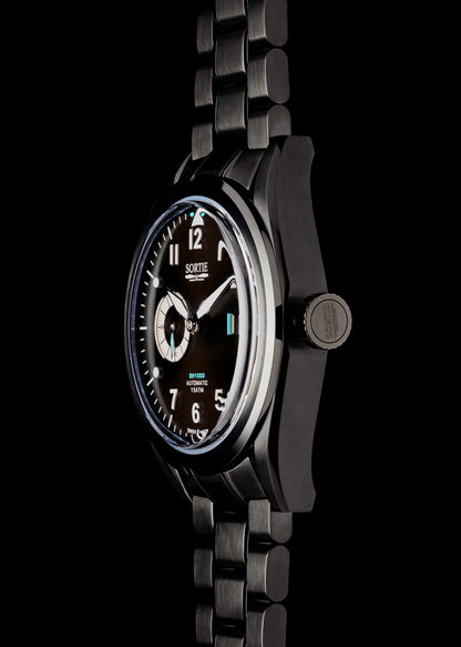 Black watch with a black dial, white numerals and blue colour accents. Includes a seconds hand dial and date display. Watch is shown from the side.