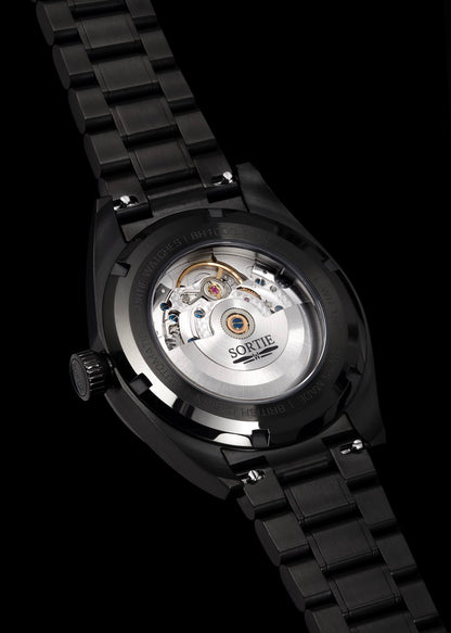 Silver stainless steel watch shown from the back with a visible mechanism shown through an exhibition window. 
