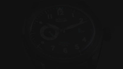 A video showing a black watch with a black dial, white numerals and blue colour accents. Includes a seconds hand dial and date display. The video shows close ups of the watch at different angles.
